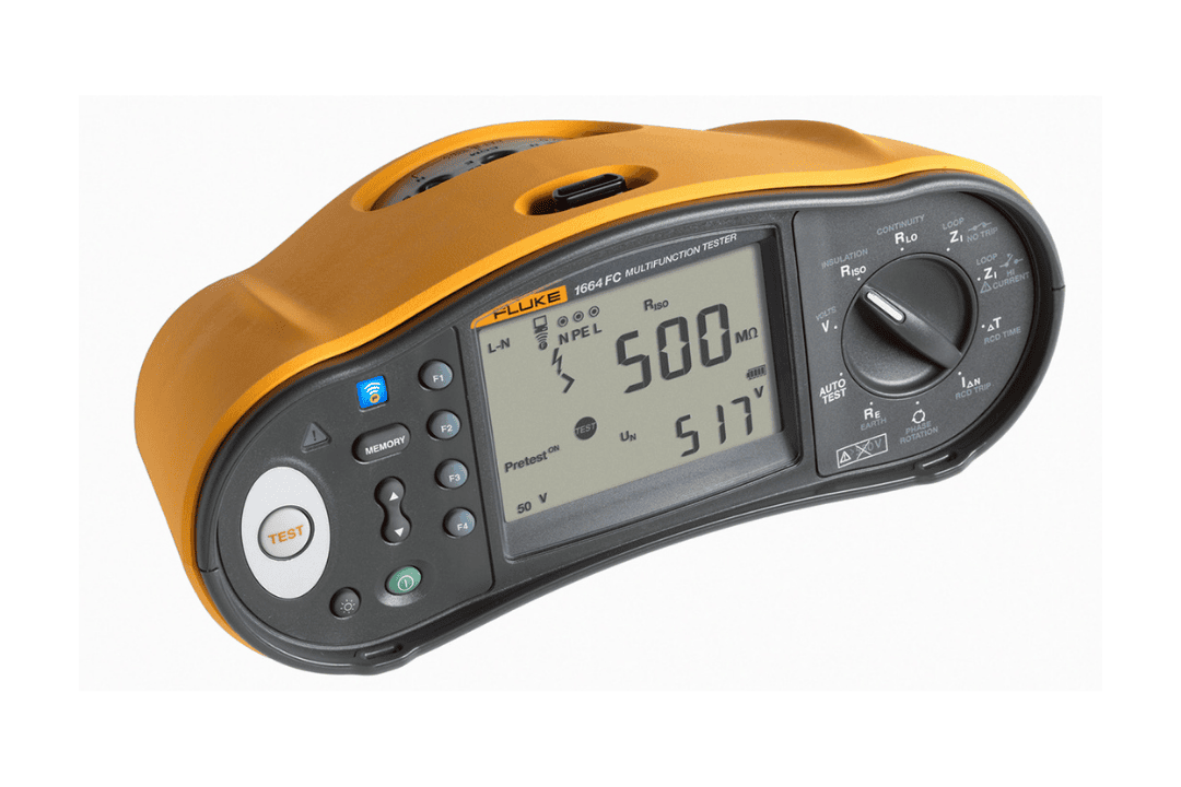 Hand holding a charging mobile phone that is connected to the wall