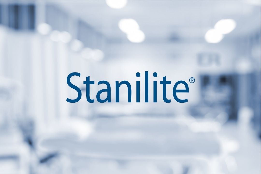 Stanilite logo on a blurred indoor background