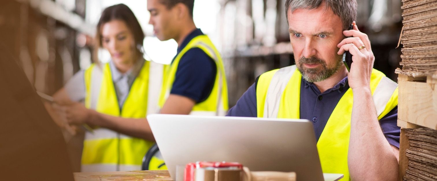 Warehouse manager ringing a supplier